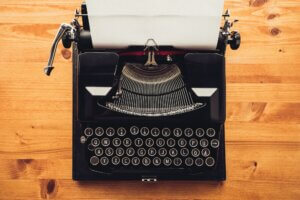 Vintage typewriter machine on writers desk
